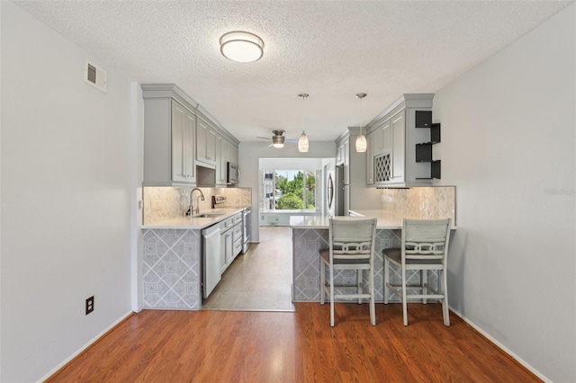 2370 Jamaican St Unit 44, Clearwater, FL 33763 - kitchen with gray cabinetry, light countertops, a ceiling fan, decorative backsplash, and a textured ceiling