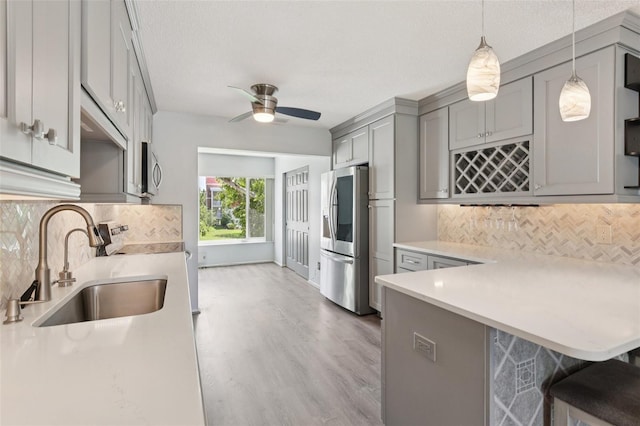 2370 Jamaican St Unit 44, Clearwater, FL 33763 - kitchen featuring gray cabinetry, stainless steel refrigerator with ice dispenser, light countertops, light wood finished floors, and ceiling fan