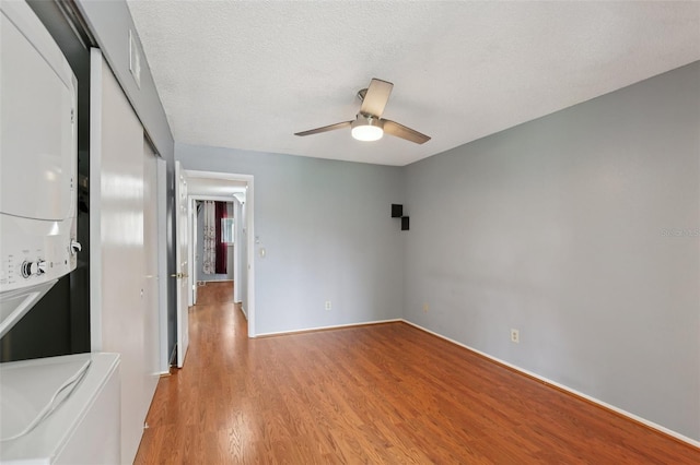 2370 Jamaican St Unit 44, Clearwater, FL 33763 - unfurnished room featuring stacked washer / dryer, light wood-type flooring, a ceiling fan, and a textured ceiling