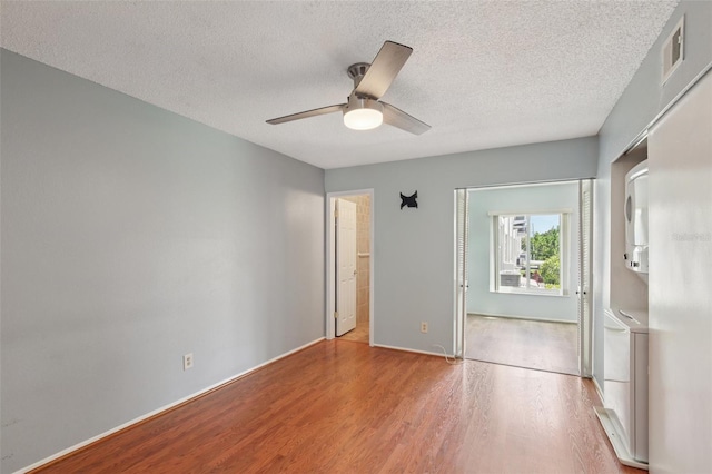 2370 Jamaican St Unit 44, Clearwater, FL 33763 - unfurnished bedroom featuring wood finished floors, a textured ceiling, and ceiling fan