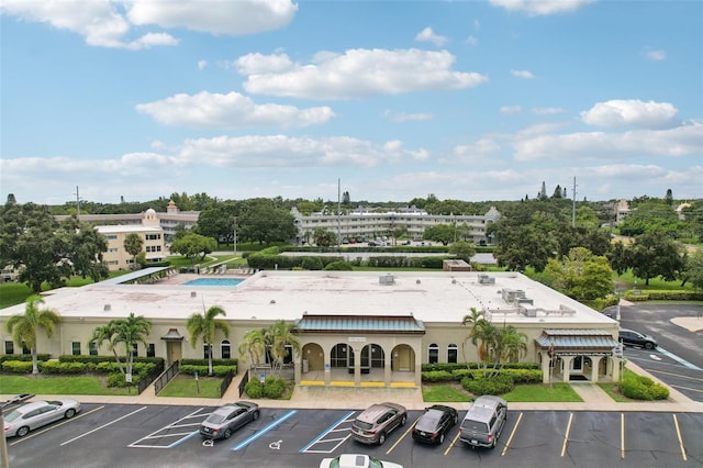 2370 Jamaican St Unit 44, Clearwater, FL 33763 - view of property featuring uncovered parking and view of scattered trees