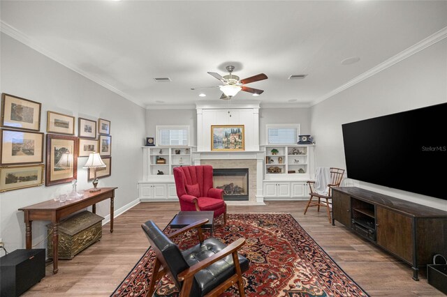 13252 SW 6th Ave, Newberry, FL 32669 - living room with a fireplace with flush hearth, wood finished floors, a ceiling fan, crown molding, and recessed lighting
