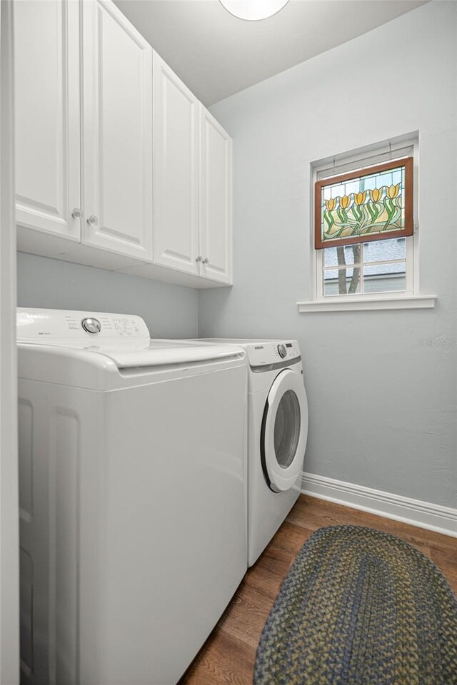 13252 SW 6th Ave, Newberry, FL 32669 - washroom with washer and clothes dryer, cabinet space, and dark wood-style floors