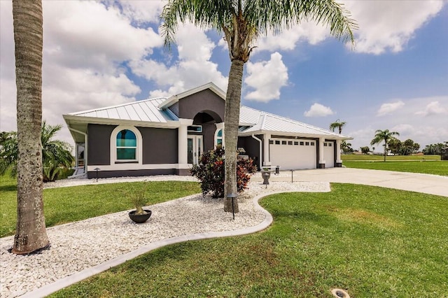 20 Bunker Ter, Rotonda West, FL 33947 - ranch-style home featuring stucco siding, an attached garage, a standing seam roof, a front lawn, and a metal roof