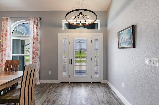 20 Bunker Ter, Rotonda West, FL 33947 - foyer with a chandelier, wood finished floors, and a textured wall