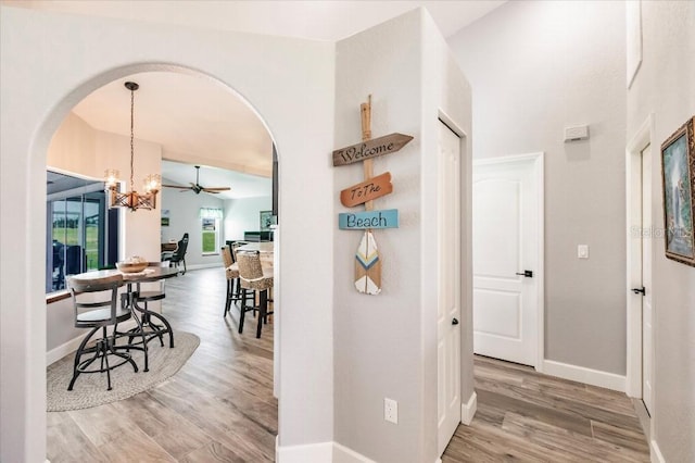 20 Bunker Ter, Rotonda West, FL 33947 - hall with arched walkways, wood finished floors, and a chandelier