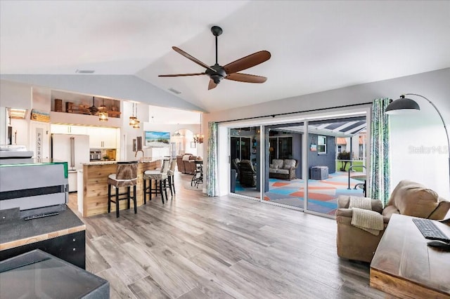 20 Bunker Ter, Rotonda West, FL 33947 - living area with vaulted ceiling, a ceiling fan, and light wood finished floors