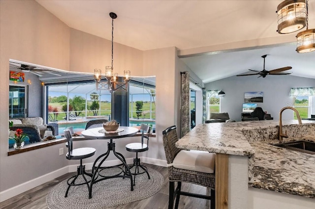 20 Bunker Ter, Rotonda West, FL 33947 - dining area with lofted ceiling, dark wood-type flooring, a ceiling fan, and a chandelier