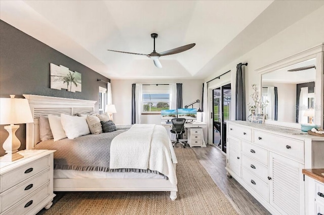 20 Bunker Ter, Rotonda West, FL 33947 - bedroom with wood finished floors, a tray ceiling, an office area, and a ceiling fan