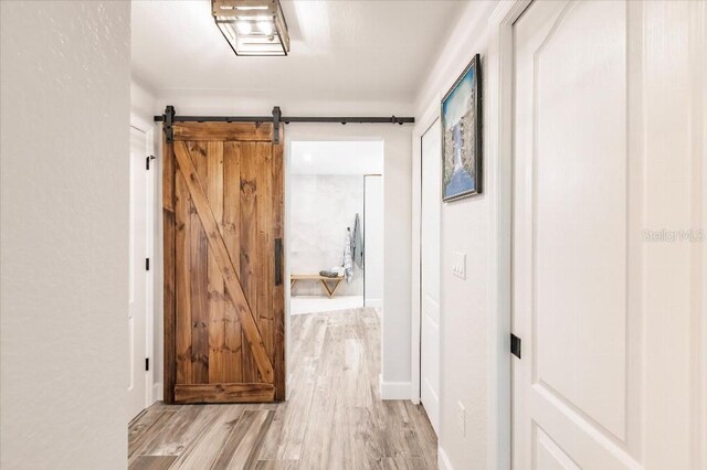 20 Bunker Ter, Rotonda West, FL 33947 - hall with light wood finished floors and a barn door