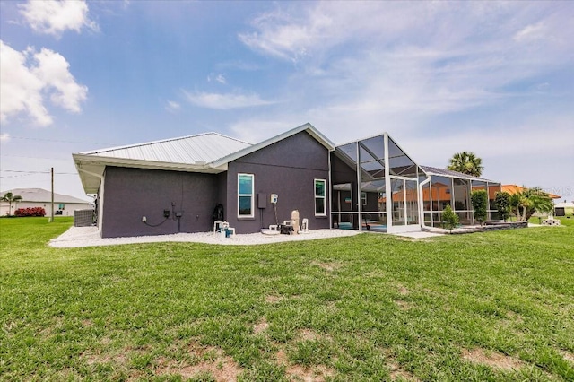 20 Bunker Ter, Rotonda West, FL 33947 - back of house featuring stucco siding, a lawn, a patio area, and a lanai