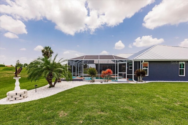 20 Bunker Ter, Rotonda West, FL 33947 - rear view of property with a yard, an outdoor pool, a lanai, stucco siding, and a metal roof