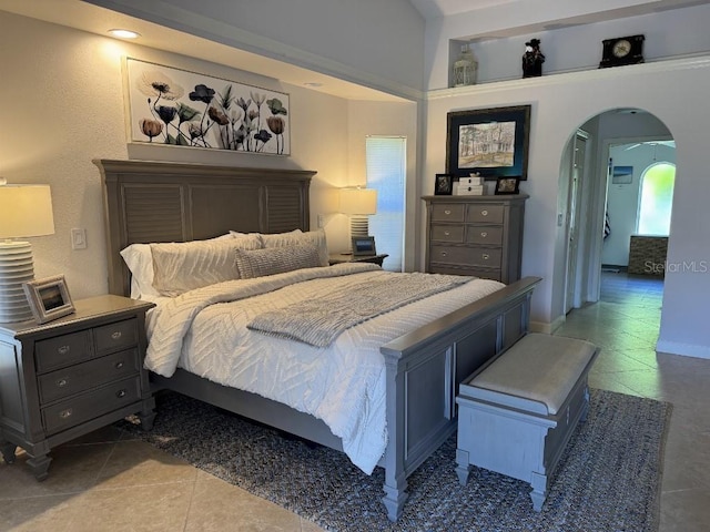 1060 Harbour Wood Dr, Punta Gorda, FL 33983 - bedroom featuring arched walkways and tile patterned floors