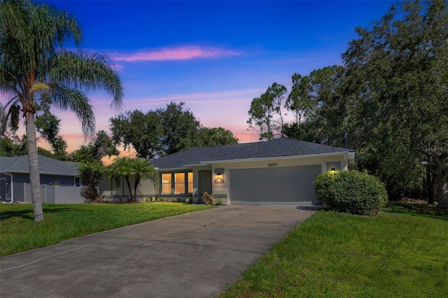 4957 N Cranberry Blvd, North Port, FL 34286 - ranch-style house with a garage, driveway, a front yard, and stucco siding