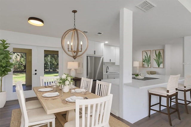 4957 N Cranberry Blvd, North Port, FL 34286 - dining space featuring wood finished floors and a chandelier