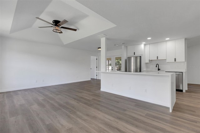 4957 N Cranberry Blvd, North Port, FL 34286 - kitchen featuring appliances with stainless steel finishes, recessed lighting, a ceiling fan, wood finished floors, and white cabinetry