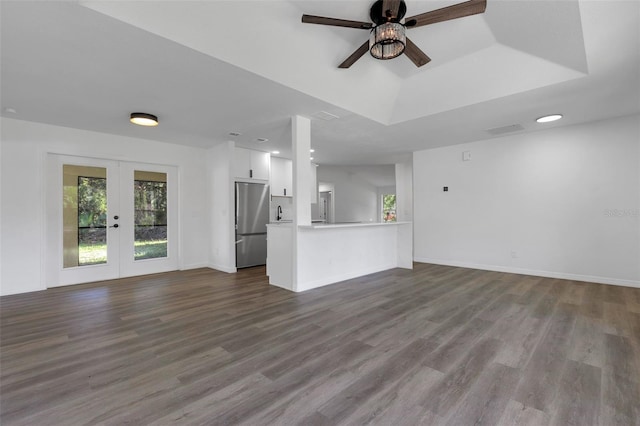 4957 N Cranberry Blvd, North Port, FL 34286 - unfurnished living room with french doors, dark wood-style floors, ceiling fan, and a raised ceiling
