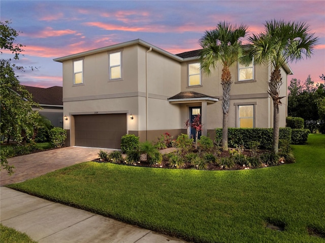 12124 Lake Blvd, Trinity, FL 34655 - traditional-style house with an attached garage, stucco siding, driveway, and a lawn