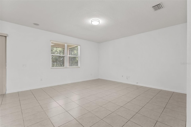 12124 Lake Blvd, Trinity, FL 34655 - spare room featuring a textured ceiling and baseboards