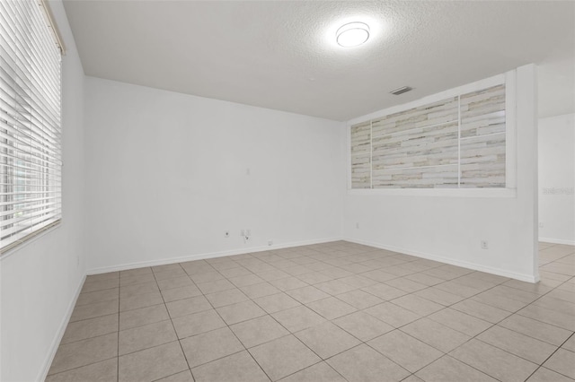 12124 Lake Blvd, Trinity, FL 34655 - unfurnished room featuring a textured ceiling and light tile patterned floors