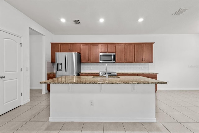12124 Lake Blvd, Trinity, FL 34655 - kitchen with stainless steel appliances, stone counters, backsplash, a kitchen island with sink, and recessed lighting