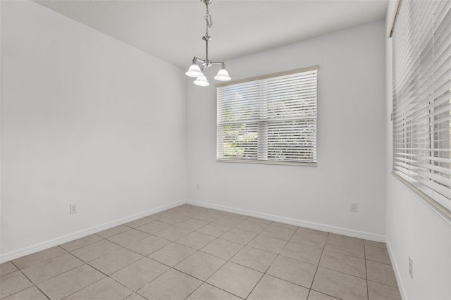 12124 Lake Blvd, Trinity, FL 34655 - unfurnished room with a chandelier and light tile patterned floors
