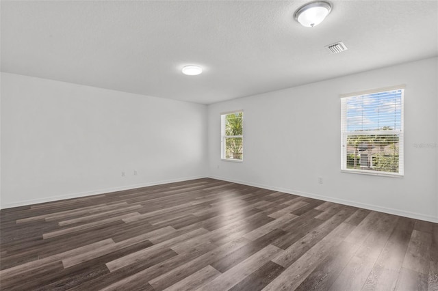 12124 Lake Blvd, Trinity, FL 34655 - empty room with dark wood finished floors and a textured ceiling