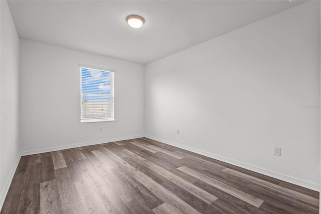 12124 Lake Blvd, Trinity, FL 34655 - unfurnished room with dark wood-style flooring and baseboards
