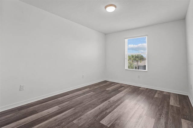 12124 Lake Blvd, Trinity, FL 34655 - unfurnished room featuring dark wood-style floors and baseboards