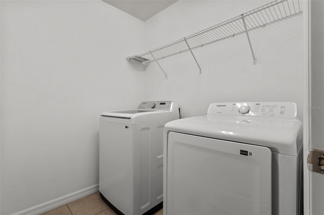 12124 Lake Blvd, Trinity, FL 34655 - laundry room featuring independent washer and dryer and light tile patterned floors