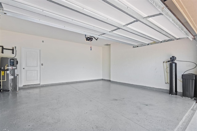 12124 Lake Blvd, Trinity, FL 34655 - garage with a garage door opener, hybrid water heater, and concrete block wall