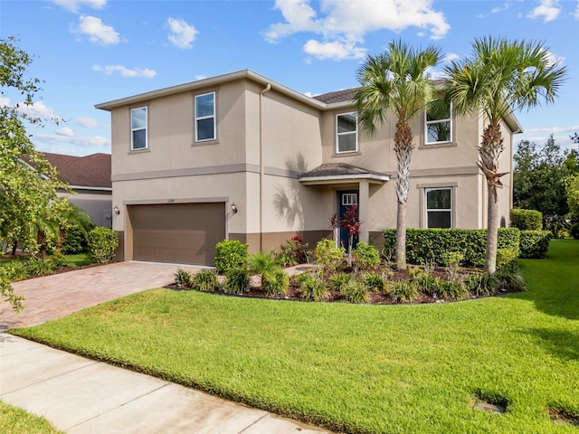 12124 Lake Blvd, Trinity, FL 34655 - traditional-style house featuring stucco siding, a garage, decorative driveway, and a front lawn