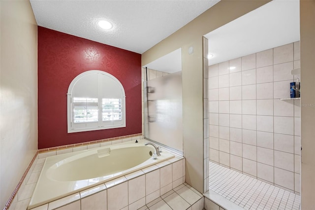 1304 N Jasmine Ave, Tarpon Springs, FL 34689 - bathroom featuring a bath, a tile shower, a textured ceiling, and an accent wall