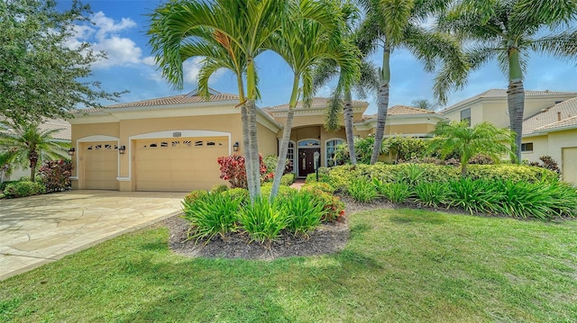15110 Sundial Pl, Lakewood Ranch, FL 34202 - mediterranean / spanish-style home with stucco siding, an attached garage, driveway, a front lawn, and a tile roof