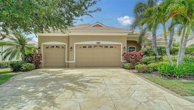 15110 Sundial Pl, Lakewood Ranch, FL 34202 - mediterranean / spanish home with a tiled roof, concrete driveway, stucco siding, and an attached garage