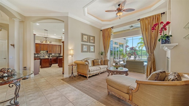 15110 Sundial Pl, Lakewood Ranch, FL 34202 - sitting room with crown molding, ceiling fan, arched walkways, and decorative columns