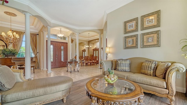 15110 Sundial Pl, Lakewood Ranch, FL 34202 - living area with ornate columns, a chandelier, ornamental molding, arched walkways, and wood finished floors