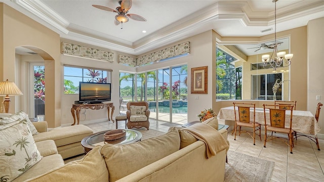 15110 Sundial Pl, Lakewood Ranch, FL 34202 - living room featuring ornamental molding, a raised ceiling, a ceiling fan, light tile patterned floors, and arched walkways