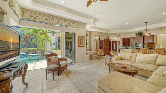 15110 Sundial Pl, Lakewood Ranch, FL 34202 - living area with crown molding, light tile patterned flooring, a chandelier, plenty of natural light, and a ceiling fan