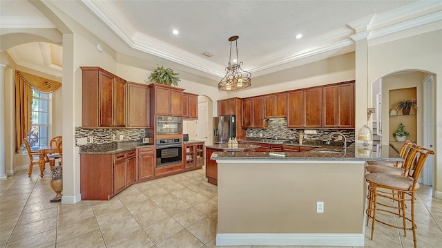 15110 Sundial Pl, Lakewood Ranch, FL 34202 - kitchen with arched walkways, appliances with stainless steel finishes, ornamental molding, dark stone counters, and backsplash