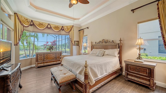 15110 Sundial Pl, Lakewood Ranch, FL 34202 - bedroom featuring ornamental molding, a tray ceiling, wood finished floors, and ceiling fan