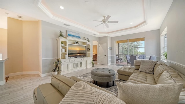 15110 Sundial Pl, Lakewood Ranch, FL 34202 - living room with a raised ceiling, ceiling fan, light wood-type flooring, and recessed lighting
