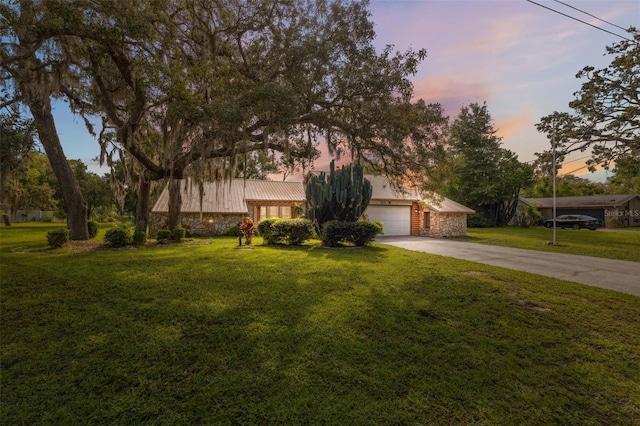 1116 Dagmar Ave, Spring Hill, FL 34606 - view of front of property with stone siding, driveway, a lawn, and a metal roof