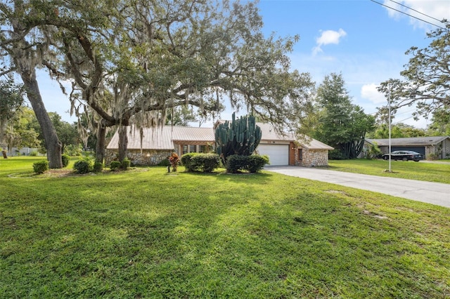 1116 Dagmar Ave, Spring Hill, FL 34606 - view of front of property featuring stone siding, driveway, a front yard, a metal roof, and a garage