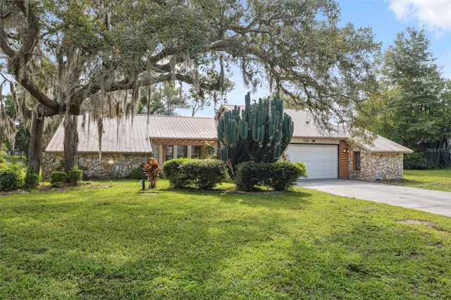 1116 Dagmar Ave, Spring Hill, FL 34606 - tri-level home with stone siding, a metal roof, concrete driveway, and a front yard