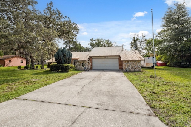 1116 Dagmar Ave, Spring Hill, FL 34606 - view of front of house with stone siding, an attached garage, a front yard, and concrete driveway