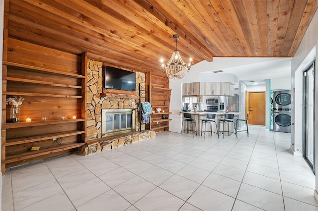1116 Dagmar Ave, Spring Hill, FL 34606 - living room with stacked washing machine and dryer, a chandelier, a stone fireplace, light tile patterned floors, and wooden ceiling