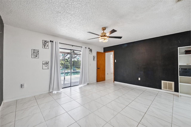 1116 Dagmar Ave, Spring Hill, FL 34606 - unfurnished room featuring a ceiling fan, a textured ceiling, and an accent wall
