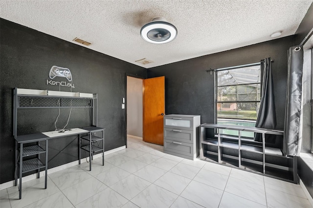 1116 Dagmar Ave, Spring Hill, FL 34606 - bedroom featuring marble look tile flooring and a textured ceiling