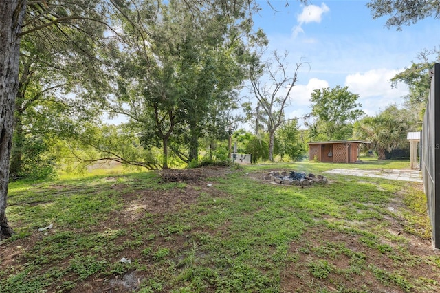 1116 Dagmar Ave, Spring Hill, FL 34606 - view of yard with an outbuilding and an outdoor fire pit